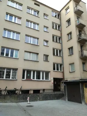 a building with a dog standing in front of it at Kremerowska Apartment in Kraków