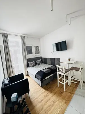 a couch with a table on top of it at Memory Apartments in Kraków