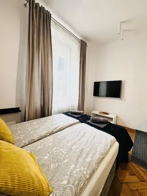 a living room with a vase of flowers on a table at Memory Apartments in Kraków