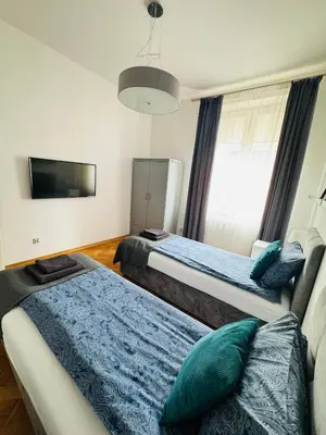 a bathroom with a glass shower and a sink at Memory Apartments in Kraków