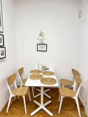 a white kitchen with white cabinets and a sink at Memory Apartments in Kraków