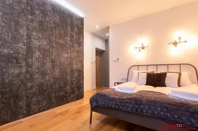 a bedroom with a bed and a black wall at Old Town Topolowa 48 in Kraków