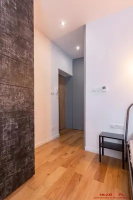 a room with white walls and a wooden floor at Old Town Topolowa 48 in Kraków