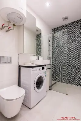 a bathroom with a washing machine and a shower at Old Town Topolowa 48 in Kraków