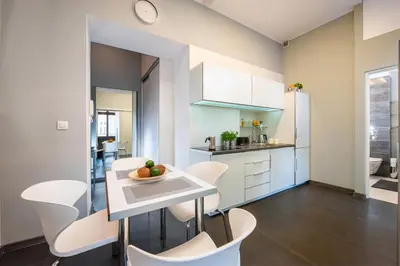a kitchen and dining room with a table and chairs at Spanko w Krakowie in Kraków
