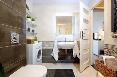 a bathroom with a washing machine and a sink at Spanko w Krakowie in Kraków