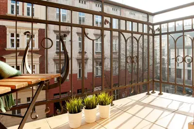 a balcony with plants and a view of a building at Spanko w Krakowie in Kraków