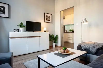 a living room with a tv and a table at Spanko w Krakowie in Kraków