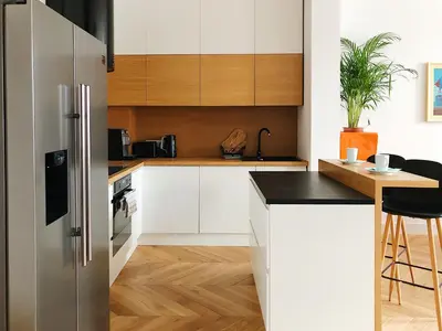 a kitchen with white cabinets and a stainless steel refrigerator at TCF Home - Big Apartment with Free Garage in Kraków