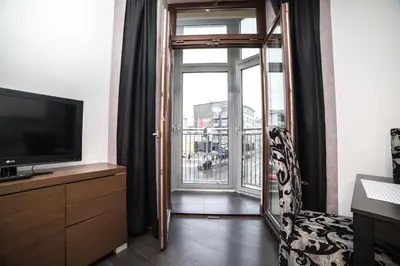 a living room with a television and a window at CracWoW VIP Apartment in Kraków