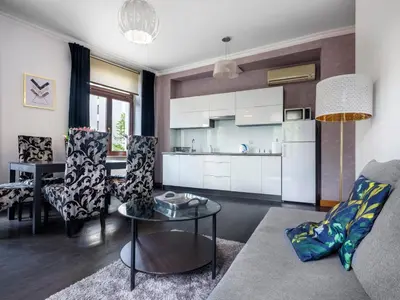 a living room with a couch and a table at CracWoW VIP Apartment in Kraków