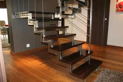 a metal staircase in a living room with wood floors at Villa ENERGY in Zator