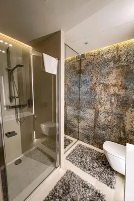 a bathroom with a shower and a toilet and a sink at Studio Łazarza 13 in Kraków