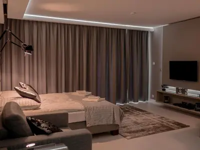 a hotel room with a bed and a television at Studio Łazarza 13 in Kraków