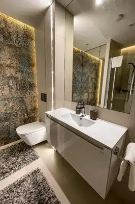 a bathroom with a sink and a toilet and a mirror at Studio Łazarza 13 in Kraków