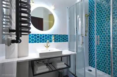 a bathroom with a sink and a shower and a mirror at Hotel Justyna in Kraków