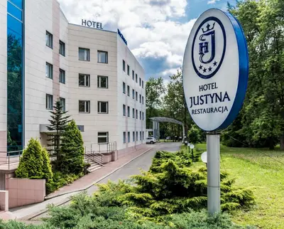 a sign for a hotel in front of a building at Hotel Justyna in Kraków