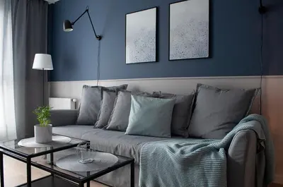 a blue living room with a couch and a table at NavyBlue apartment Cracow free parking TV in Kraków