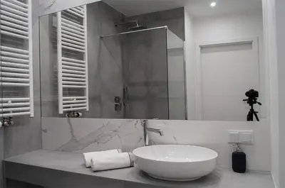 a white bathroom with a sink and a mirror at NavyBlue apartment Cracow free parking TV in Kraków