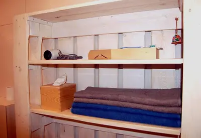 a wooden shelf with towels and a box on it at Friedleina 7 Kamienica Prezydencka in Kraków