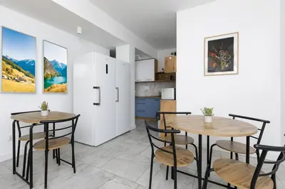 a kitchen and dining room with two tables and chairs at PrzyStań S7 in Smroków