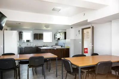 a kitchen and dining room with tables and chairs at PrzyStań S7 in Smroków