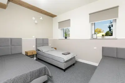 a bedroom with two beds and a window at PrzyStań S7 in Smroków