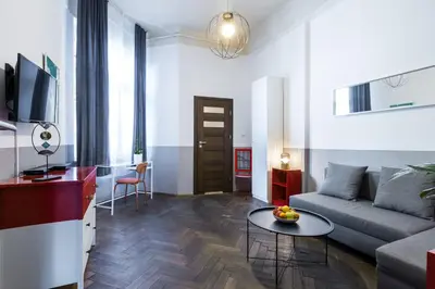 a living room with a couch and a table at Friendhouse Apartments Starovislna in Kraków