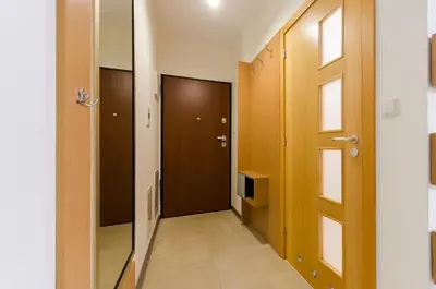 a hallway with two doors and a window at Family Apartments - Private Parking in Kraków