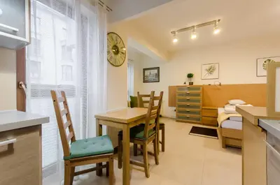a kitchen and dining room with a table and chairs at Family Apartments - Private Parking in Kraków