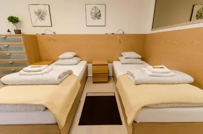 a room with two beds with towels on them at Family Apartments - Private Parking in Kraków