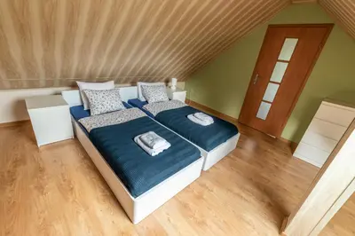 a bedroom with a large bed with blue blankets and pillows at Agroturystyka 