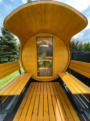 a wooden bench with a window in the center at Agroturystyka 