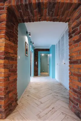 an empty room with a brick wall and a hallway at BRAND NEW ! Lovely Apartment in the fabulous location OLD TOWN JEWISH TOWN WAWEL CASTLE in Kraków