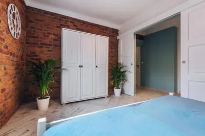 a bedroom with a brick wall and a bed at BRAND NEW ! Lovely Apartment in the fabulous location OLD TOWN JEWISH TOWN WAWEL CASTLE in Kraków