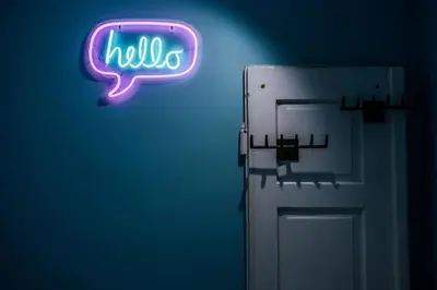 a neon sign that says hello next to a refrigerator at BRAND NEW ! Lovely Apartment in the fabulous location OLD TOWN JEWISH TOWN WAWEL CASTLE in Kraków