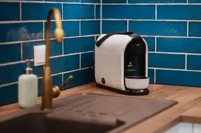 a toaster sitting on a kitchen counter next to a sink at BRAND NEW ! Lovely Apartment in the fabulous location OLD TOWN JEWISH TOWN WAWEL CASTLE in Kraków