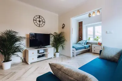 a living room with a couch and a tv at BRAND NEW ! Lovely Apartment in the fabulous location OLD TOWN JEWISH TOWN WAWEL CASTLE in Kraków