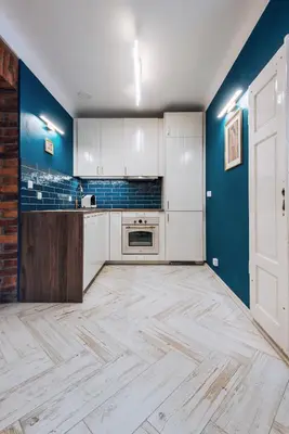a kitchen with white cabinets and blue walls at BRAND NEW ! Lovely Apartment in the fabulous location OLD TOWN JEWISH TOWN WAWEL CASTLE in Kraków