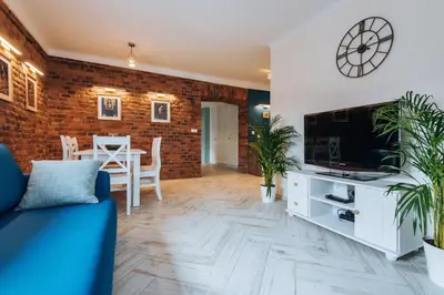 a living room with a blue couch and a tv at BRAND NEW ! Lovely Apartment in the fabulous location OLD TOWN JEWISH TOWN WAWEL CASTLE in Kraków