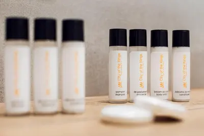 a row of four bottles of moisturizers sitting on a table at City of the Kings - Inca Apartment in Kraków