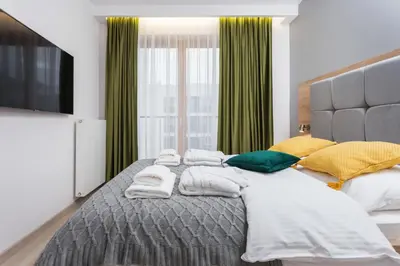 a bedroom with a large bed with towels on it at City of the Kings - Inca Apartment in Kraków