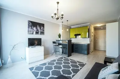 a living room with a kitchen and a dining room at Charming studio Center of Krakow in Kraków