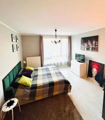 a bedroom with a bed and a television in it at Charming studio Center of Krakow in Kraków