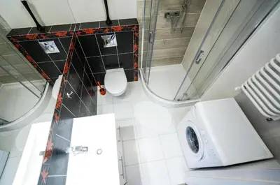 a bathroom with a washing machine and a toilet at Charming studio Center of Krakow in Kraków