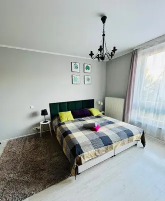 a bedroom with a bed with a checkered blanket at Charming studio Center of Krakow in Kraków