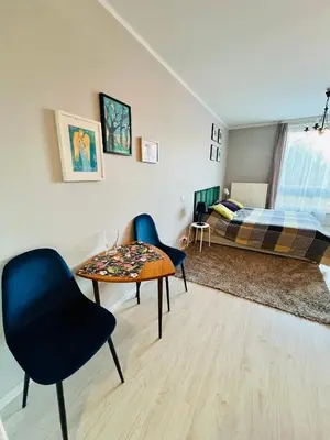 a room with a table and chairs and a bed at Charming studio Center of Krakow in Kraków
