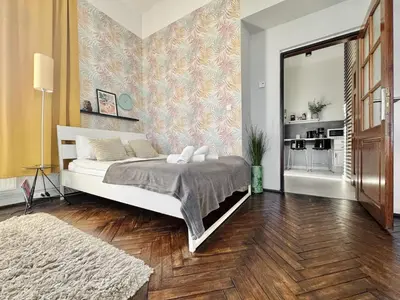 a bedroom with a bed and a mirror in it at GREEN APARTMENTS #Kazimierz, building B in Kraków
