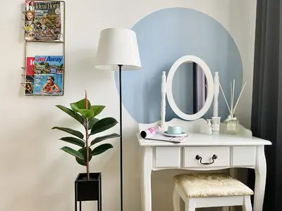 a dressing table with a lamp and a mirror at GREEN APARTMENTS #Kazimierz, building B in Kraków