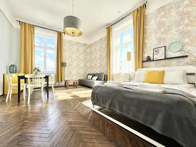 a bedroom with a bed and a dining room at GREEN APARTMENTS #Kazimierz, building B in Kraków